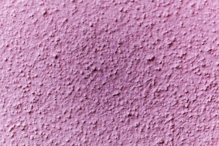 Macro photo of the surface of a pink painted wall.の写真素材