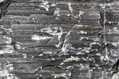 Macro photo of the surface of a geological fault in a dark marble from the Austrian Alps.の写真素材