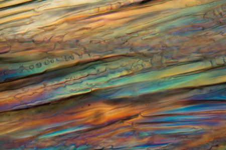 Frozen beer under a microscope and in polarized light. The photo shows ice crystals developed in...