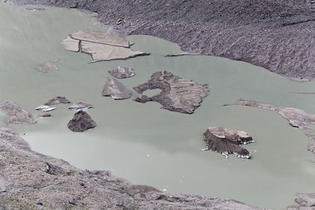 Glacier lake and alpine slopes at the Pasterze glacier in the Austrian Alps.