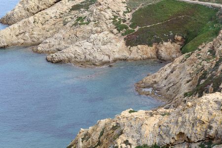 Rocks at the coast in Northern Corsica near Ile Rousse, France.の写真素材