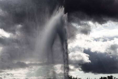 A water fountain with dark sky as background.の写真素材