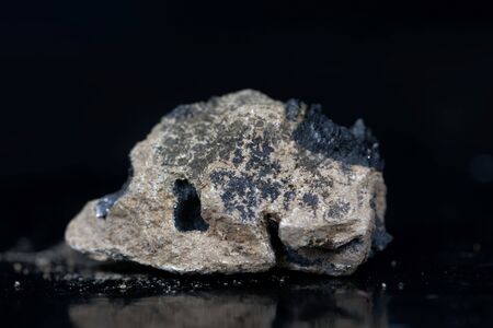 A macro photo of calcium carbide or calcium acetylide with a black background.