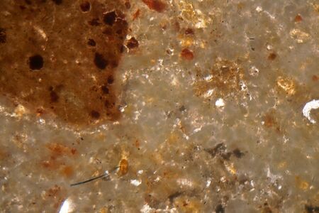 Microscopic photo of a petrographic thin section of roman concrete, opus caementicium, in polarized...