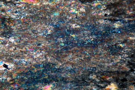 Microscope photo of a petrographic thin section of a lapis lazuli gem stone, with polarized light.   の写真素材
