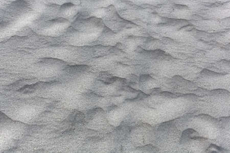 Abstract photo of textures in gray coarse grained sand.の写真素材