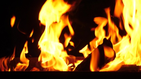 fire burns in the grill at night, close-upの写真素材