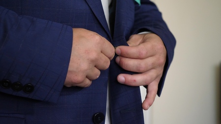 Businessman man buttons up his hands on his jacket in morning going to work. oncept of business...