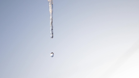 Dripping icicles. Melting Icicles, against the blue sky. close-up. Spring drops.の写真素材