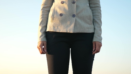 Girl is bankrupt. Beggar business. Ruined enterprise. Woman debtor turns out empty pockets against blue skyの写真素材