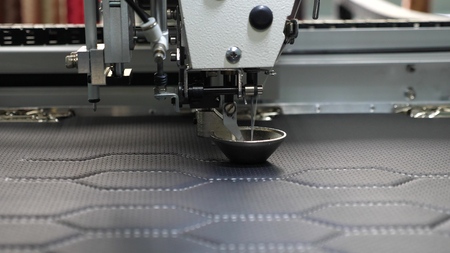 Robot sewing machine. automatic sewing machine. Robotics works in the tailoring production line. The...
