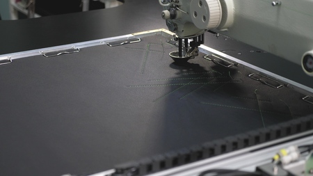 Robot sewing machine. computer controls the sewing machine. automatic sewing machine. automated...