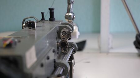 process of sewing leather goods. The needle of the sewing machine in motion. two needles of the...