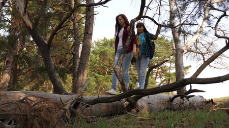 Sexy girls traveler with backpacks on their shoulders enjoy freedom. Girlfriends laugh over...