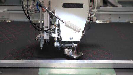 Robotics with cnc works in sewing a production line. Robot sewing machine. computer controls sewing machine. automatic sewing machine. Automated machine embroidery.の写真素材