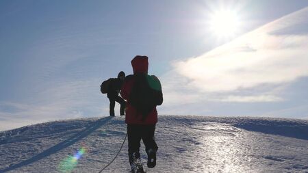 team of business people climb to the top of their success. teamwork business people. three climber...