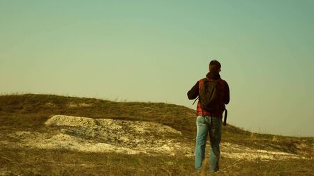 traveler with a backpack goes on meeting with another traveler. sports tourism. collaboration of business people. The team of travelers goes to victory and success. team work in business.の写真素材
