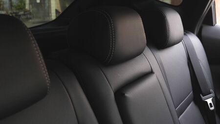 artificial leather rear seats in the car. beautiful leather car interior design. luxury leather seats in the car. Black leather seat covers in the car.の写真素材