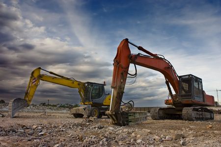 Two bulldozers parked in a blowned building