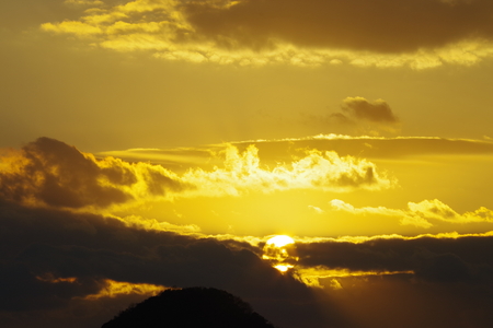 Sunrise through the cloudsの写真素材
