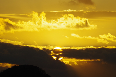 Sunrise through the cloudsの写真素材