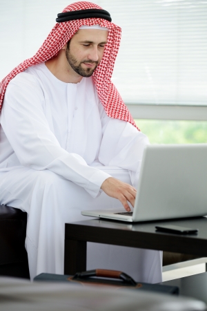 Modern arabic businessman on office working on laptopの写真素材