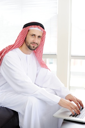 Modern arabic businessman on office working on laptopの写真素材