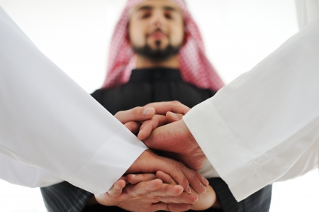 Successful Arabic business people shaking hands over a dealの写真素材