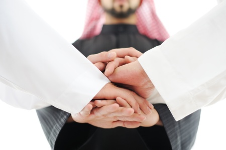 Successful Arabic business people shaking hands over a dealの写真素材