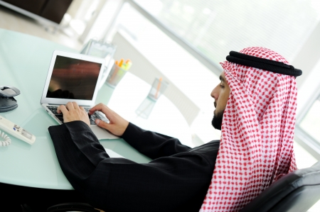 Modern arabic businessman on office working on laptopの写真素材