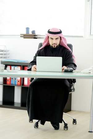 Modern arabic businessman on office working on laptopの写真素材
