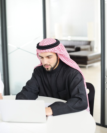 Modern arabic businessman on office working on laptopの写真素材