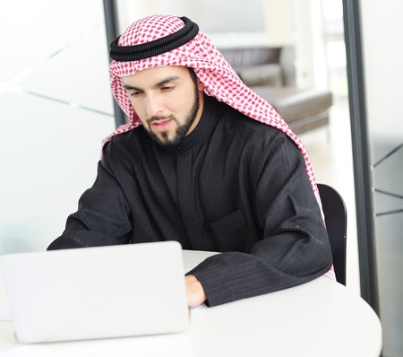 Modern arabic businessman on office working on laptopの写真素材