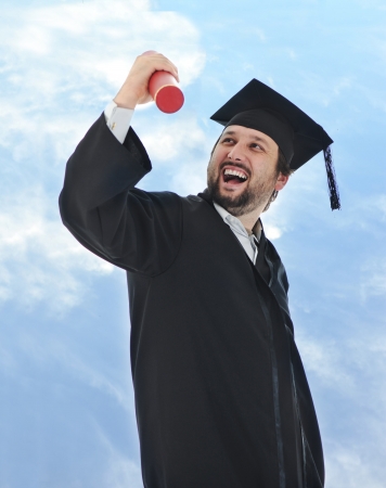 excited graduate student in gown の写真素材