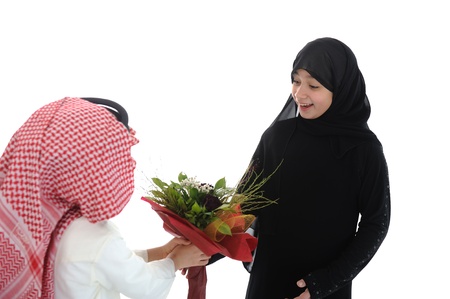 Arabic boy with keffiyeh and flowers present for sisterの写真素材