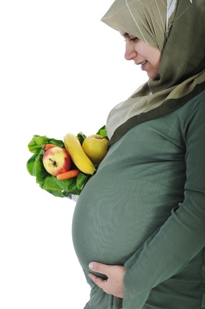 Pregnant muslim woman with healthy foodの写真素材