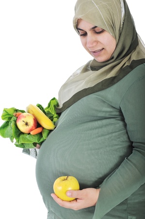 Pregnant muslim woman with healthy foodの写真素材