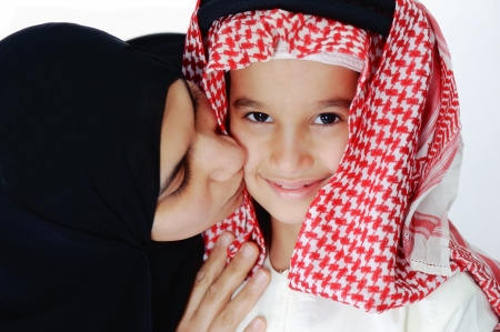 Arabic Muslim mother kissing her little sonの写真素材
