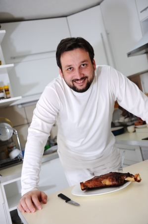 Portrait of a young man in his kitchenの写真素材