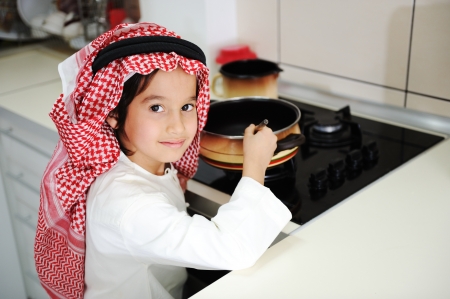 Little kid boy is cookingの写真素材