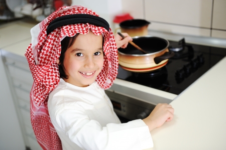 Little kid boy is cookingの写真素材