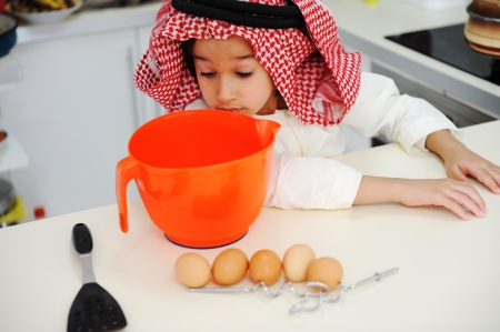 Little kid boy is cookingの写真素材