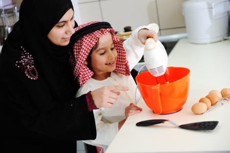 Muslim mother and little son in the kitchenの写真素材