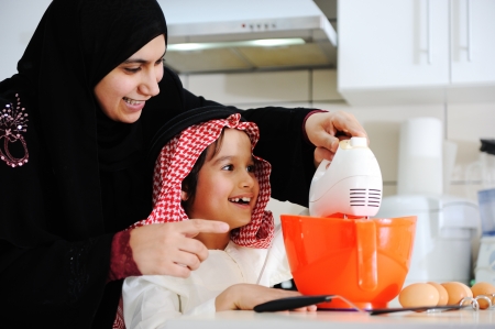 Muslim mother and little son in the kitchenの写真素材
