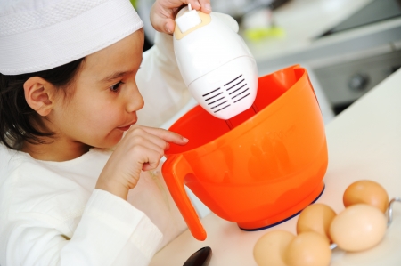 Little kid boy is cookingの写真素材