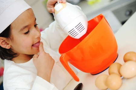 Little kid boy is cookingの写真素材