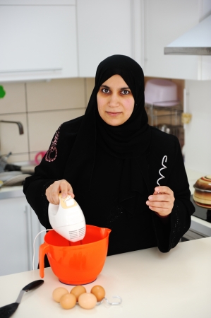 Beautiful muslim woman  in the kitchenの写真素材