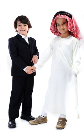 Arabic and caucasian little businessmen handshakingの写真素材
