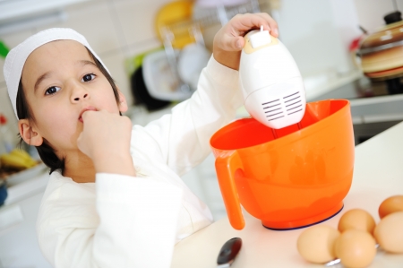 Little kid boy is cookingの写真素材