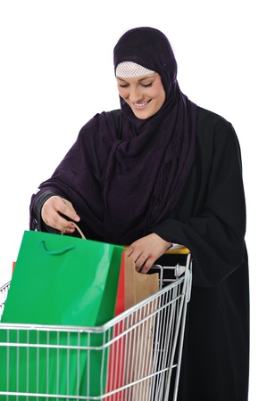 happy muslim woman with shopping cart  over whiteの写真素材